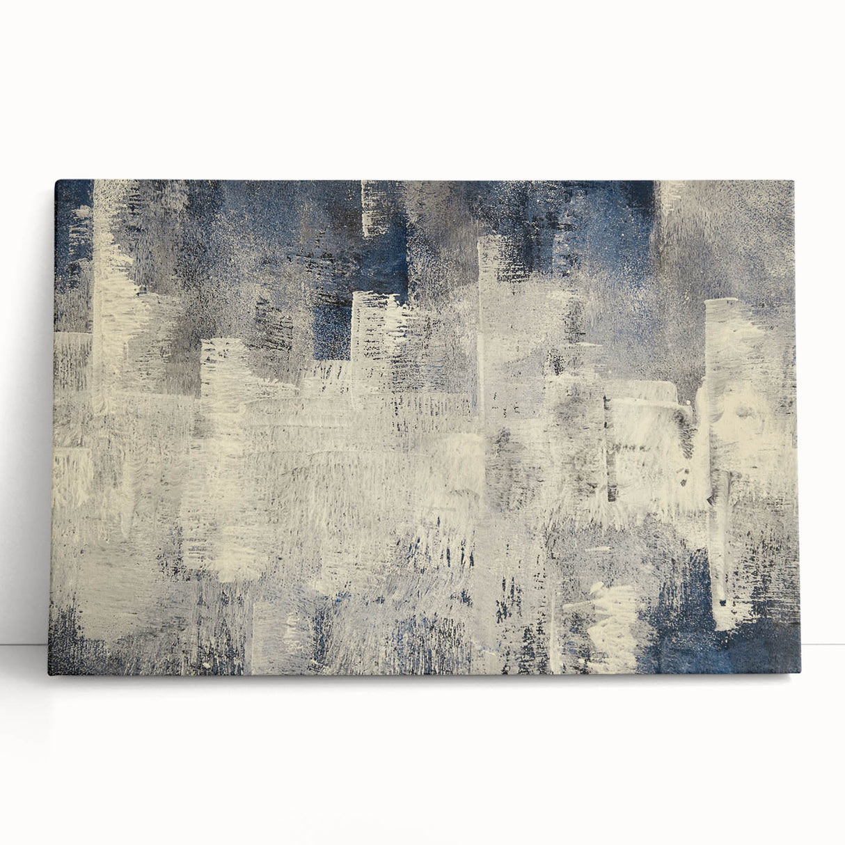 Abstract wall art featuring vibrant strokes and lines in shades of blue, orange, and yellow, elegantly stretched on canvas and leaning against a neutral wall, perfect for modern home decor.