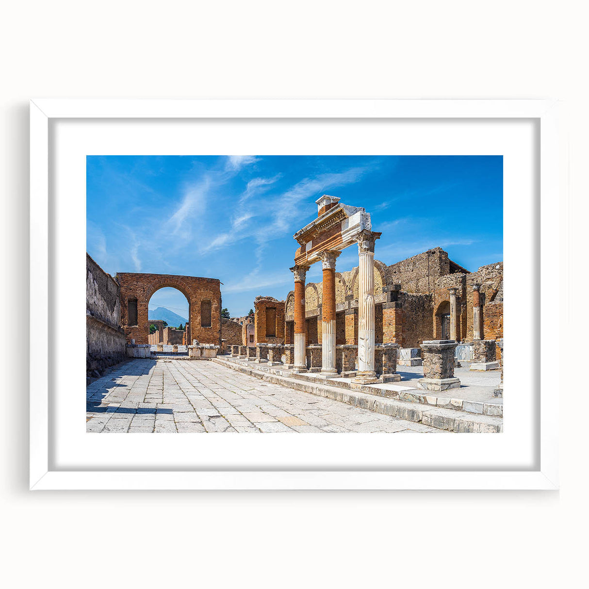 Abstract art print of ancient ruins in muted beige and gray, framed with a white mat, suitable for dining room decor.