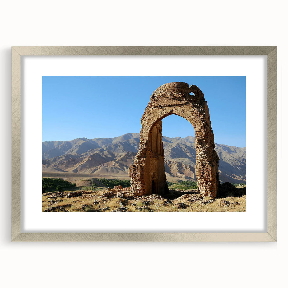 Textured art print of abstract ancient ruins in muted earth tones, framed in silver, ideal for bedroom art.