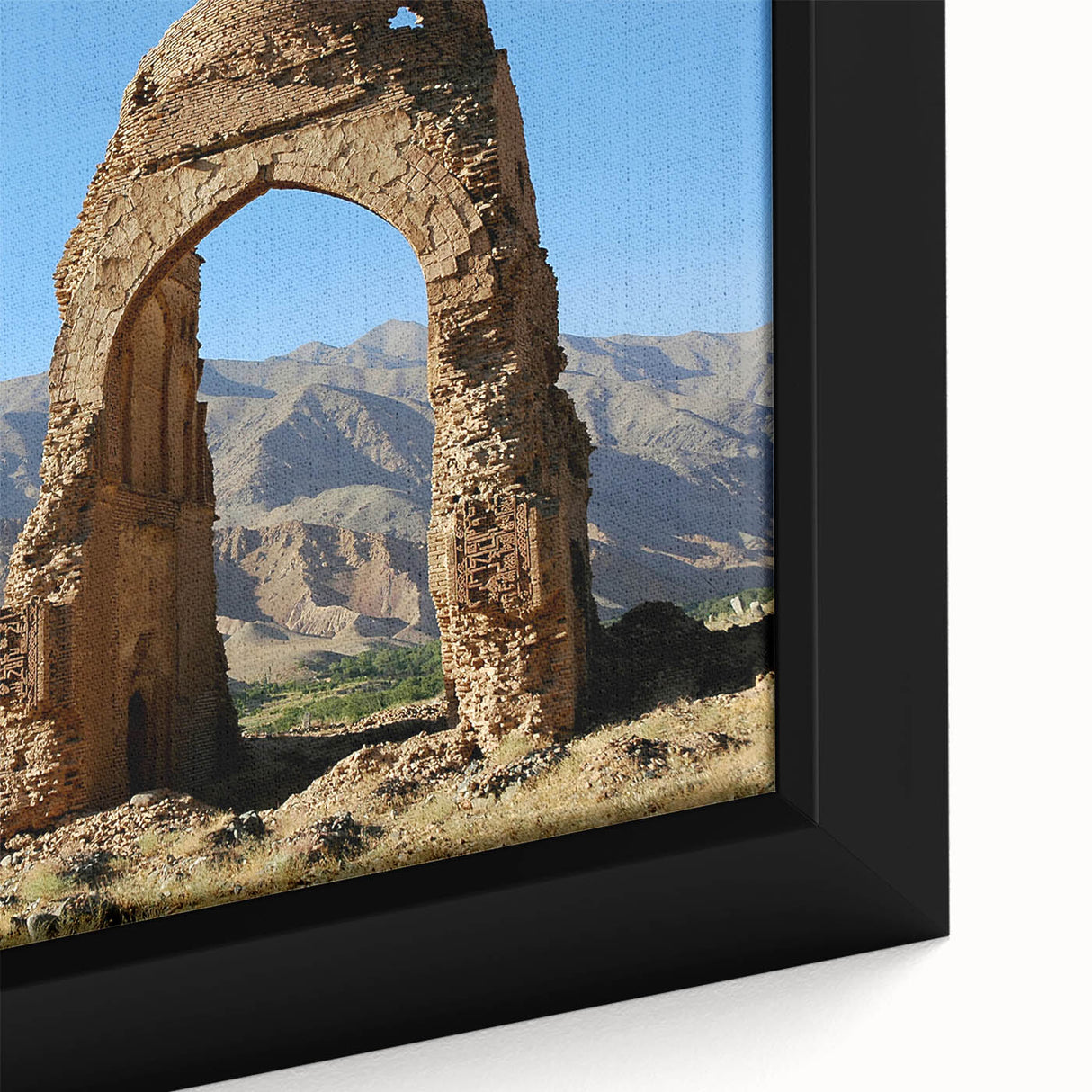 Close-up of a black wall art depicting ancient ruins in a textured style with colorful accents, framed canvas.