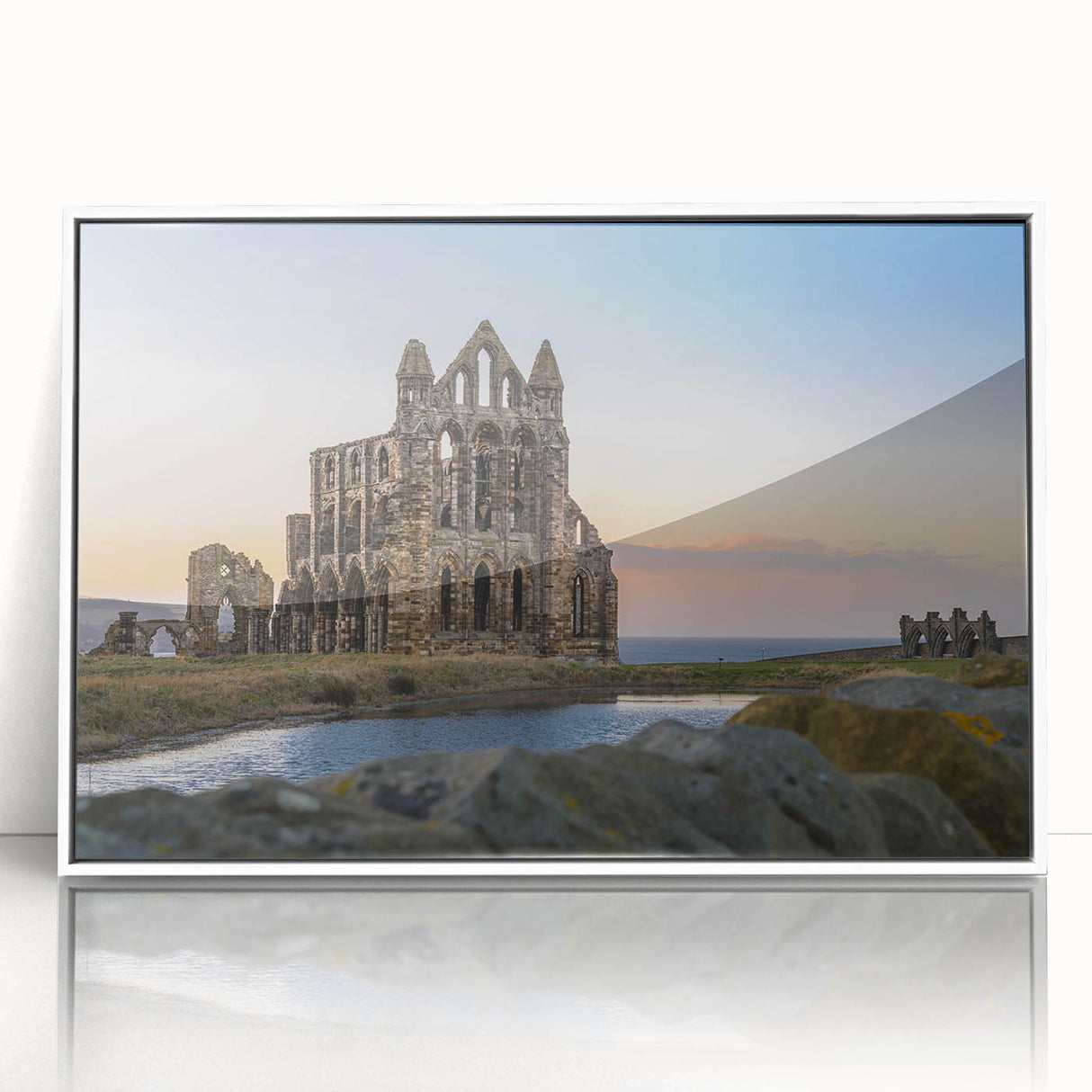 Art deco poster of ancient ruins in muted gray and blue tones, acrylic print framed in white.