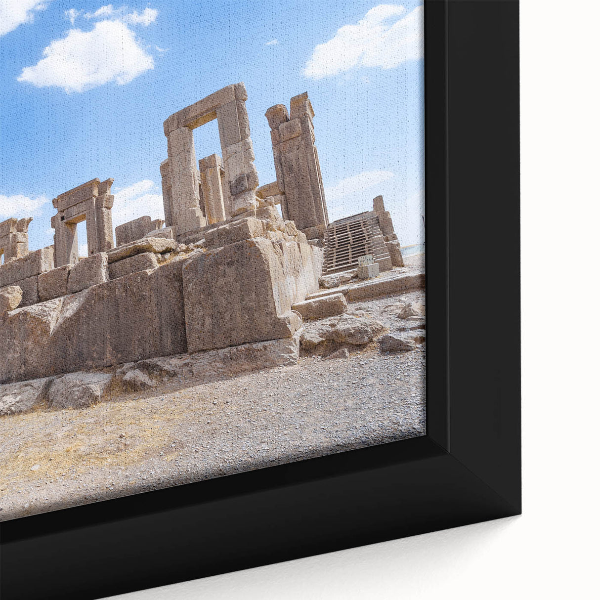 Close-up of a textured black wall art depicting ancient ruins in vibrant colors on framed canvas.