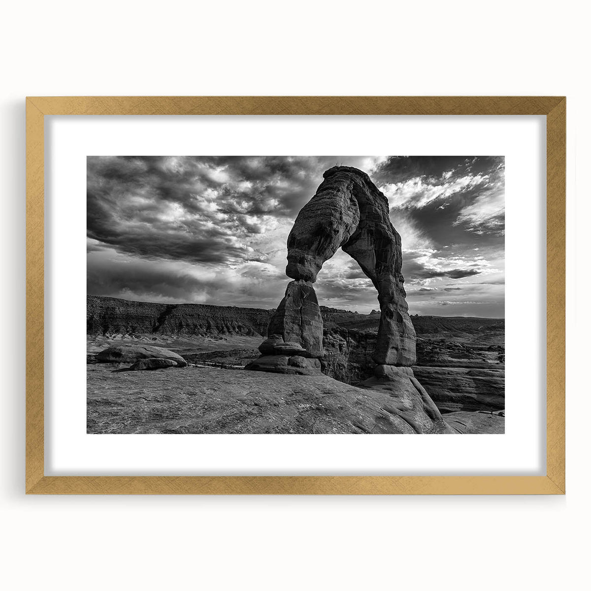 Abstract art print featuring a series of overlapping arches in muted gray and gold tones, framed in gold.
