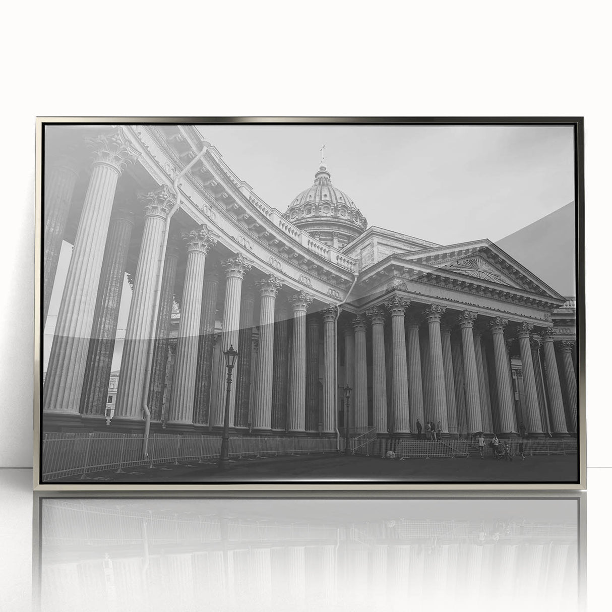Mid-century modernist art featuring silver-framed acrylic print of architectural columns in monochrome tones.