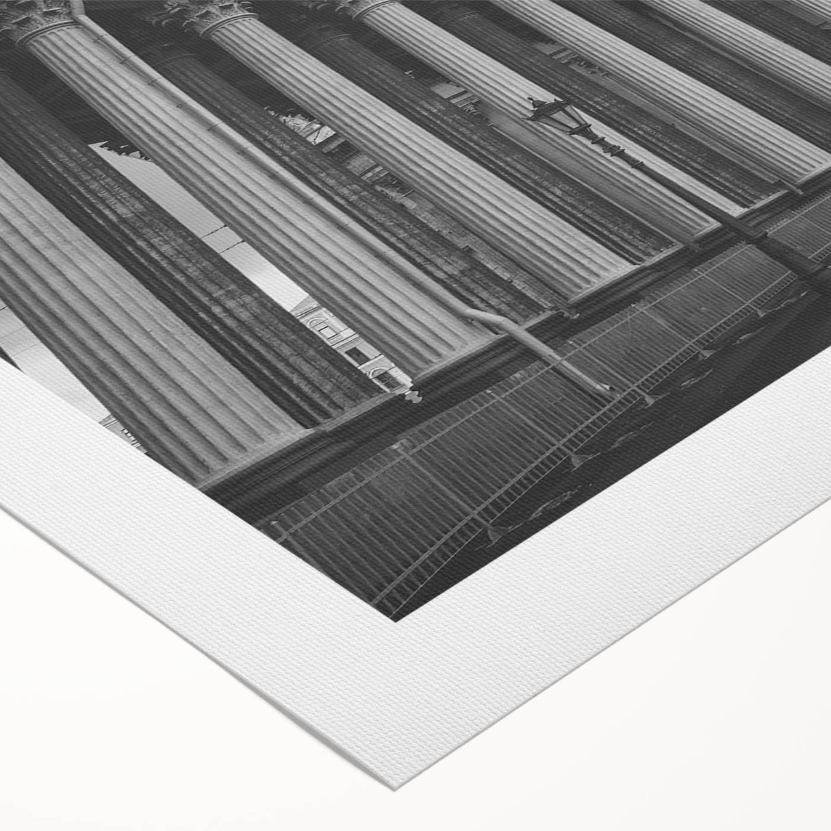 Art deco poster featuring a series of ornate columns in muted beige and white tones on a rolled canvas.