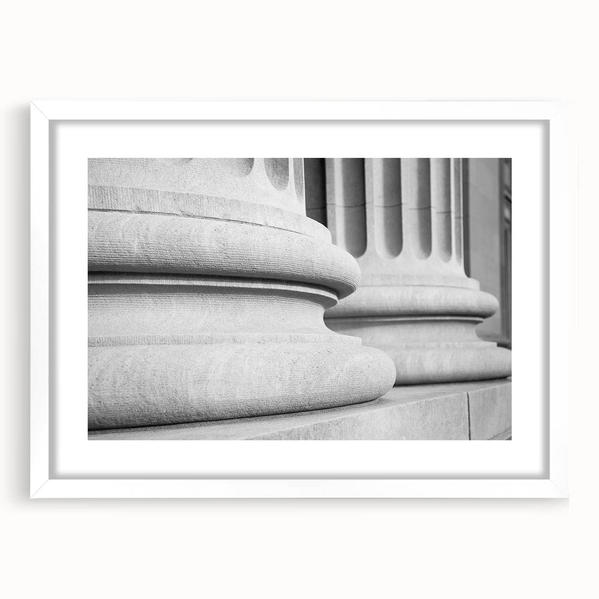 Abstract art print featuring a series of vertical columns in muted gray tones, framed in white, ideal for dining room decor.