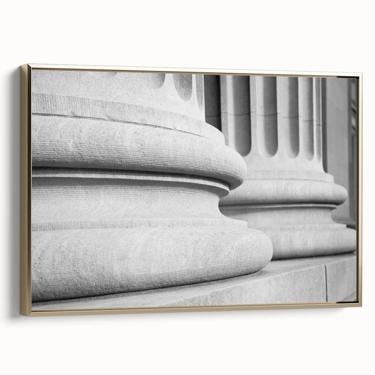Framed canvas wall art featuring a vintage poster of a landscape with architectural columns in black and gold tones.