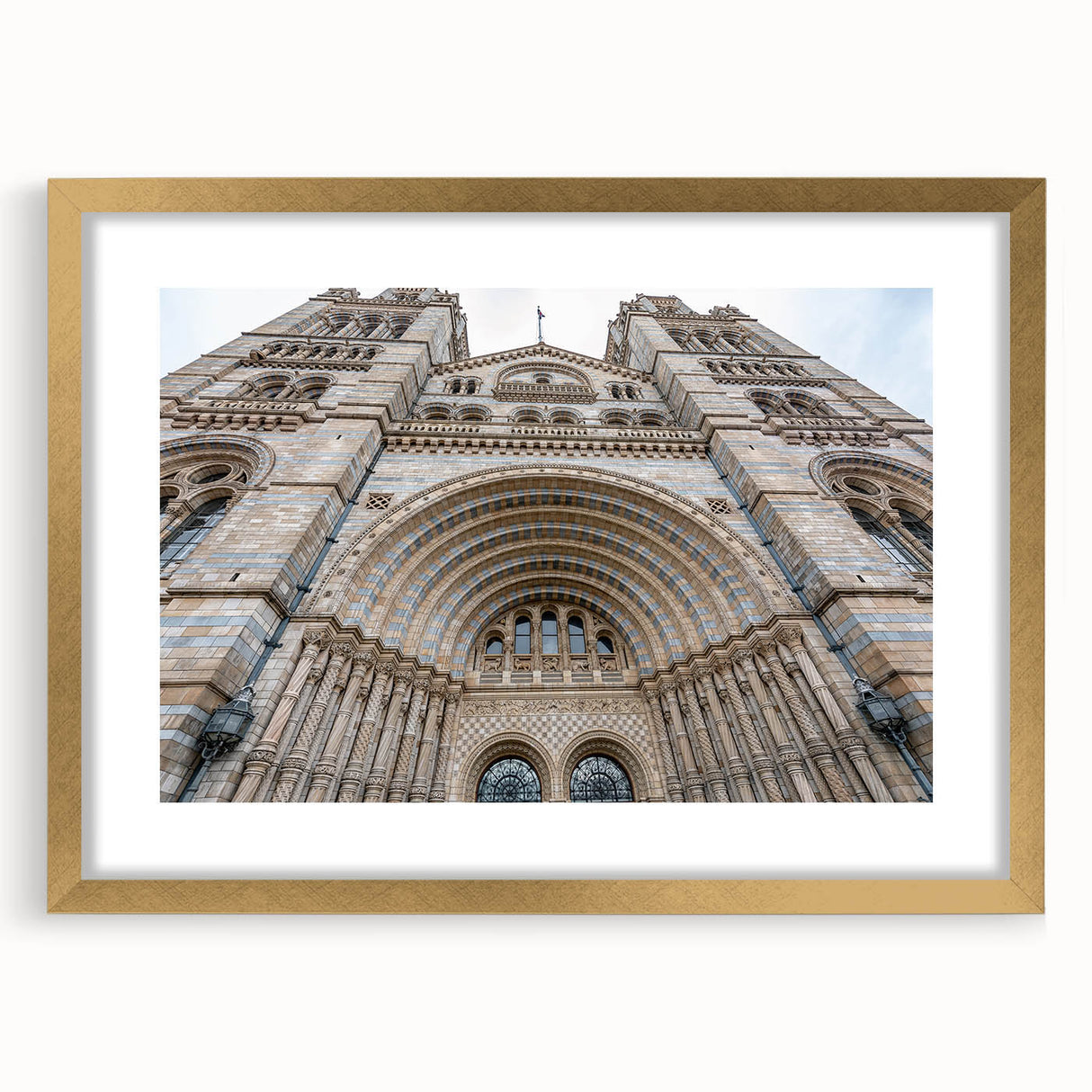 Textured abstract art print of a palace design in gold and beige tones on a framed mat, suitable for bedroom decor.