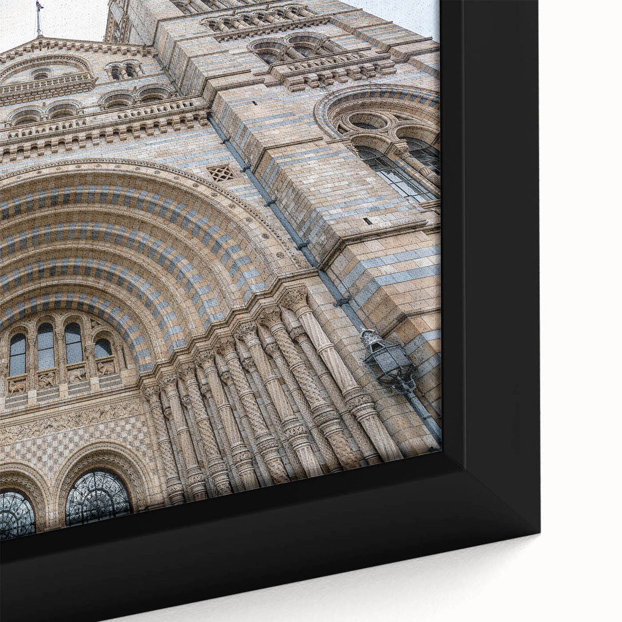 Close-up of a black wall art featuring a textured, colorful abstract palace design on a framed canvas.