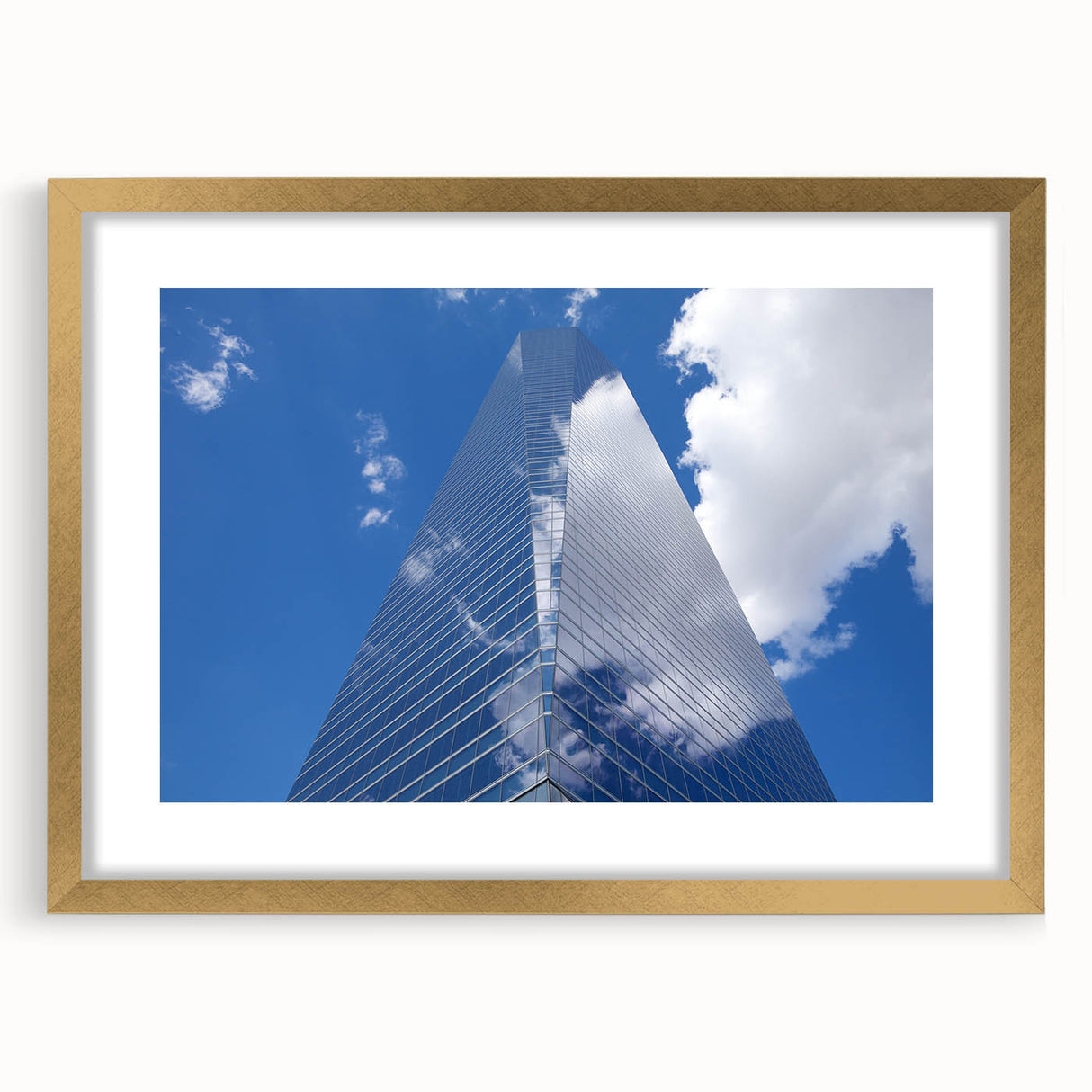 Textured abstract art print of skyscrapers in gold frame, ideal for bedroom art, in neutral and gray tones.
