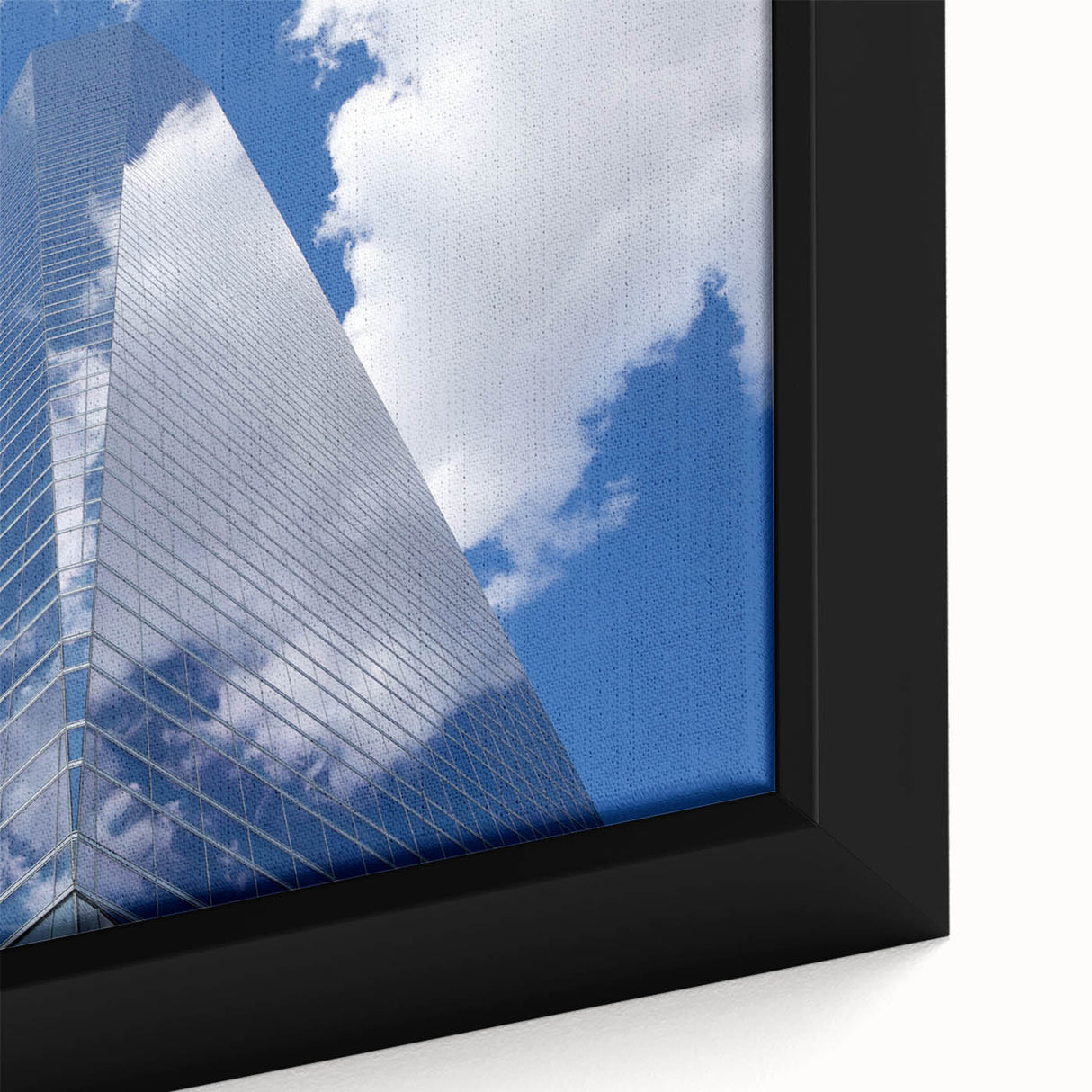 Close-up of a black wall art featuring a textured skyscraper design in vibrant colors on a framed canvas.
