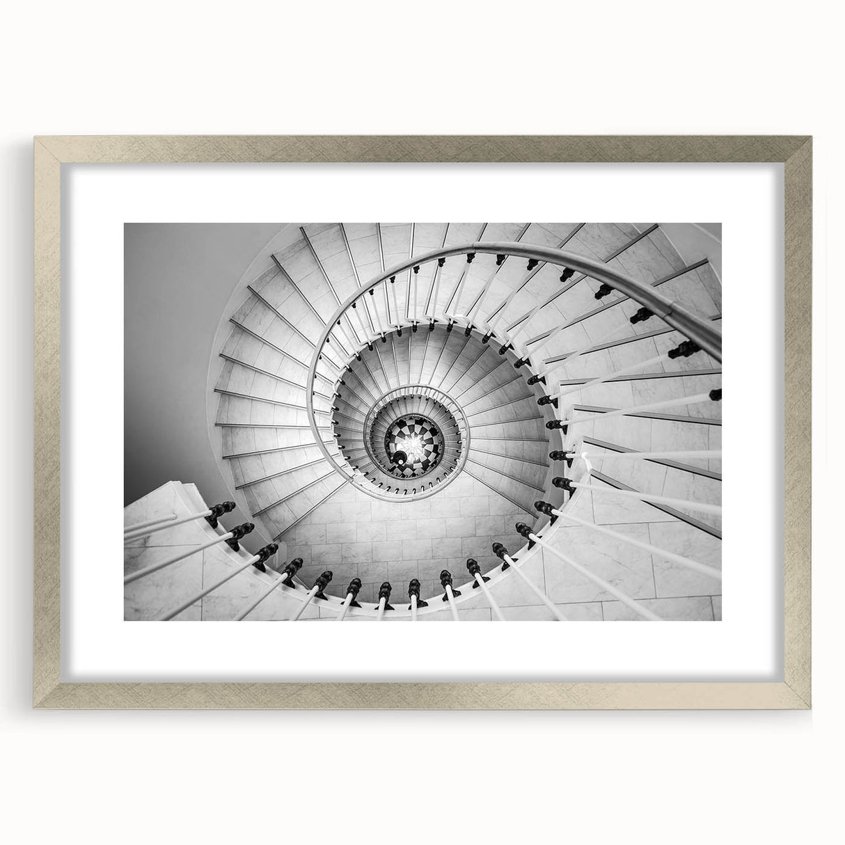 Textured abstract art print of a spiral staircase in muted gray tones, framed in silver, ideal for bedroom art.