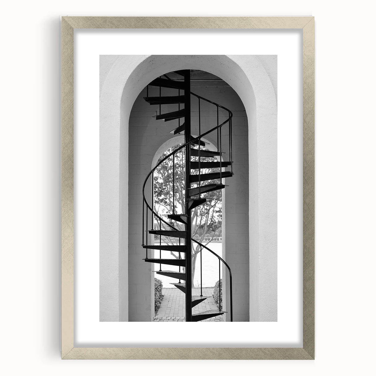 Textured abstract art print of a spiral staircase in muted gray tones on a framed silver mat, ideal for bedroom art.