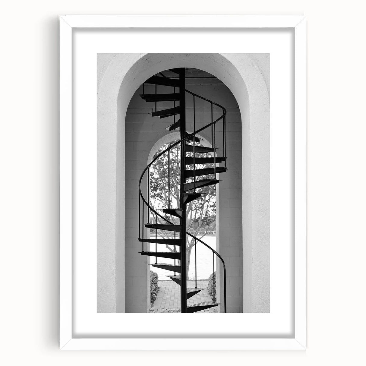 Abstract art print of a spiral staircase in monochrome, framed with a white mat, suitable for bedroom or dining room decor.