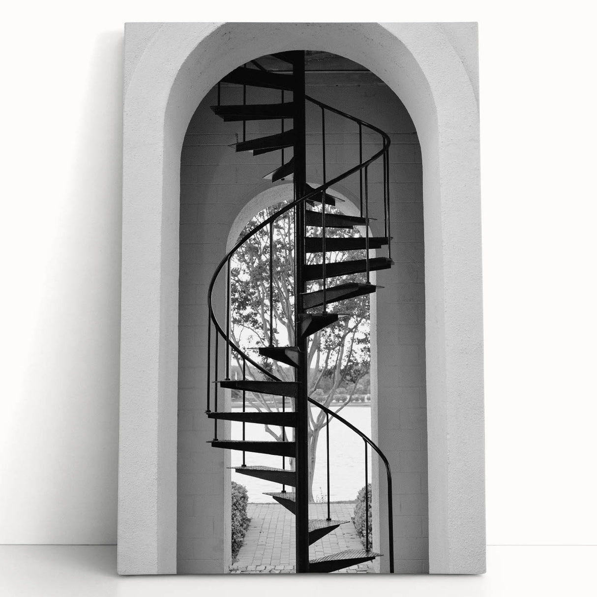 Black and white photograph of a spiral staircase on stretched canvas, suitable as large art for kitchen or bedroom.