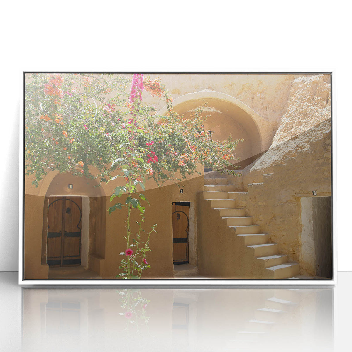 Framed acrylic print of a Tunisian landscape in art deco style, featuring soft earth tones, ideal for modern nursery decor.