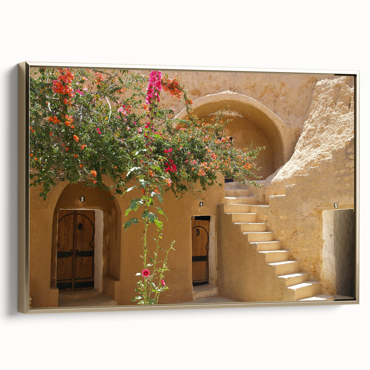 Framed canvas featuring a vintage-style landscape painting of a Tunisian scenery in gold and black tones.