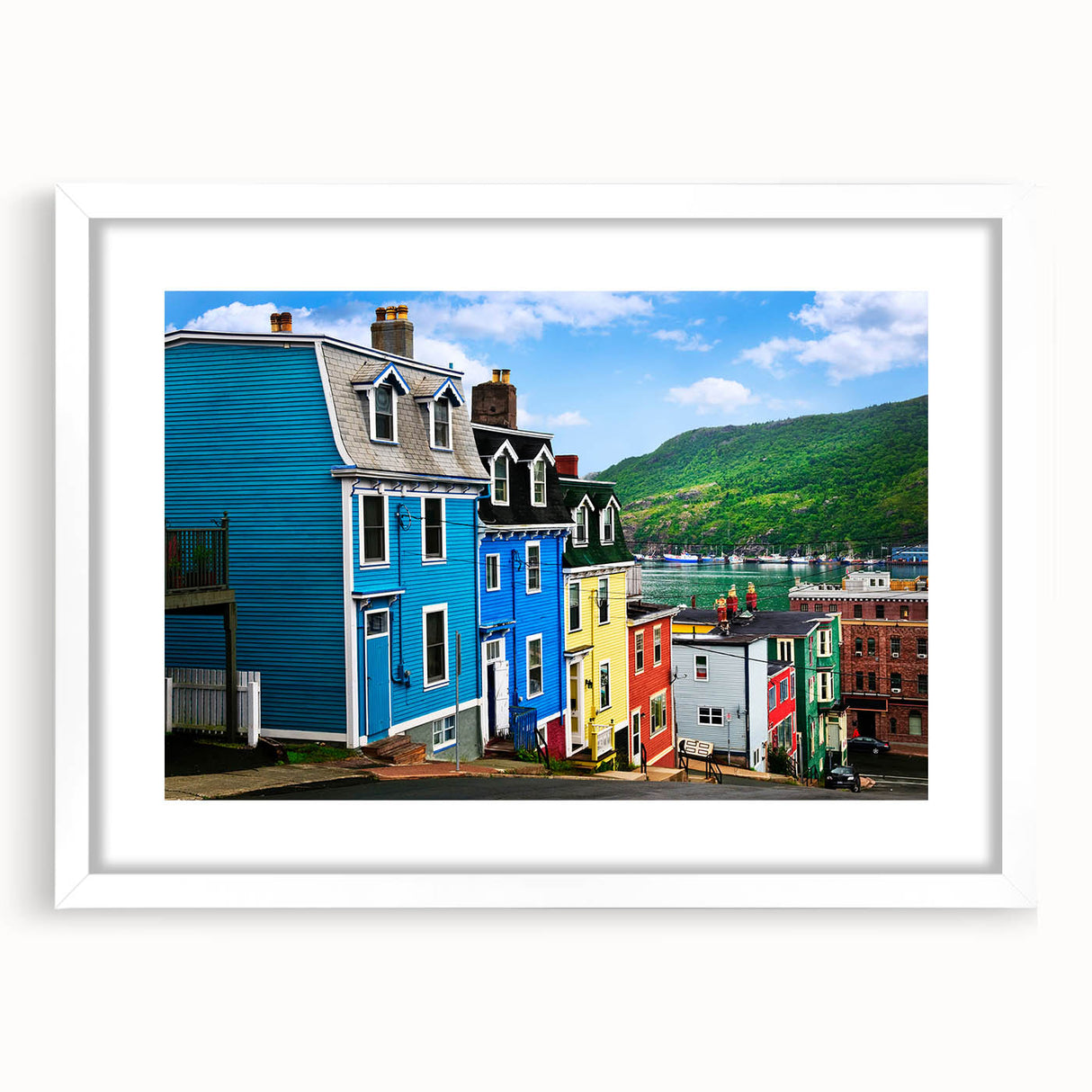 Abstract art print of Newfoundland scenery in muted green and blue tones, framed with a white mat.