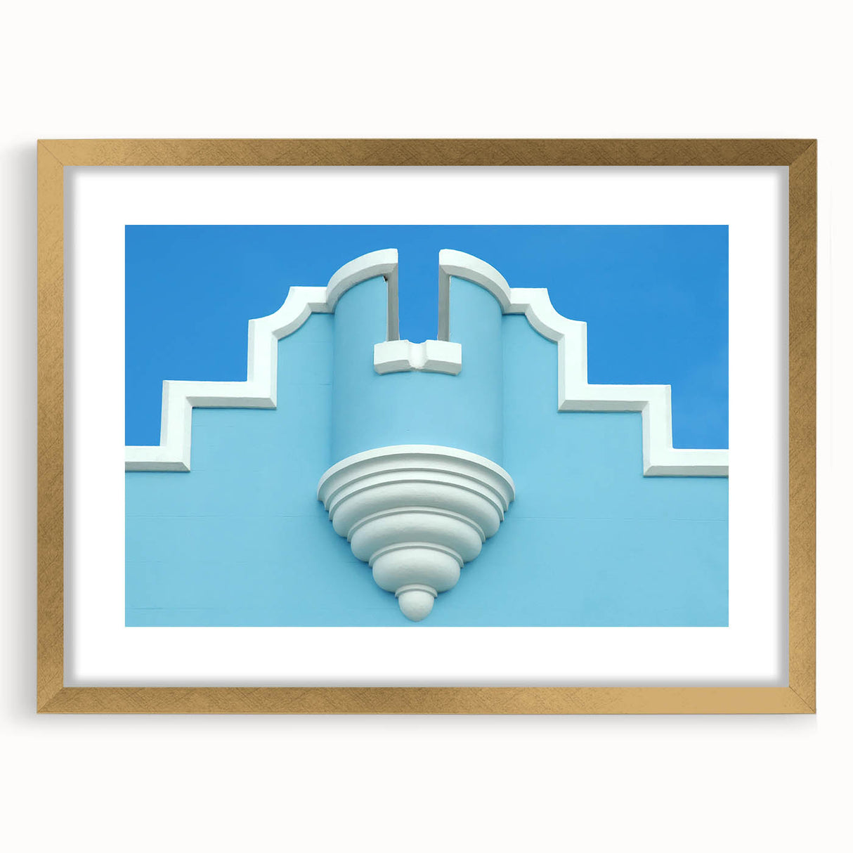 Abstract art print of a Caribbean landscape in muted blue and green tones, framed in gold, ideal for dining room decor.