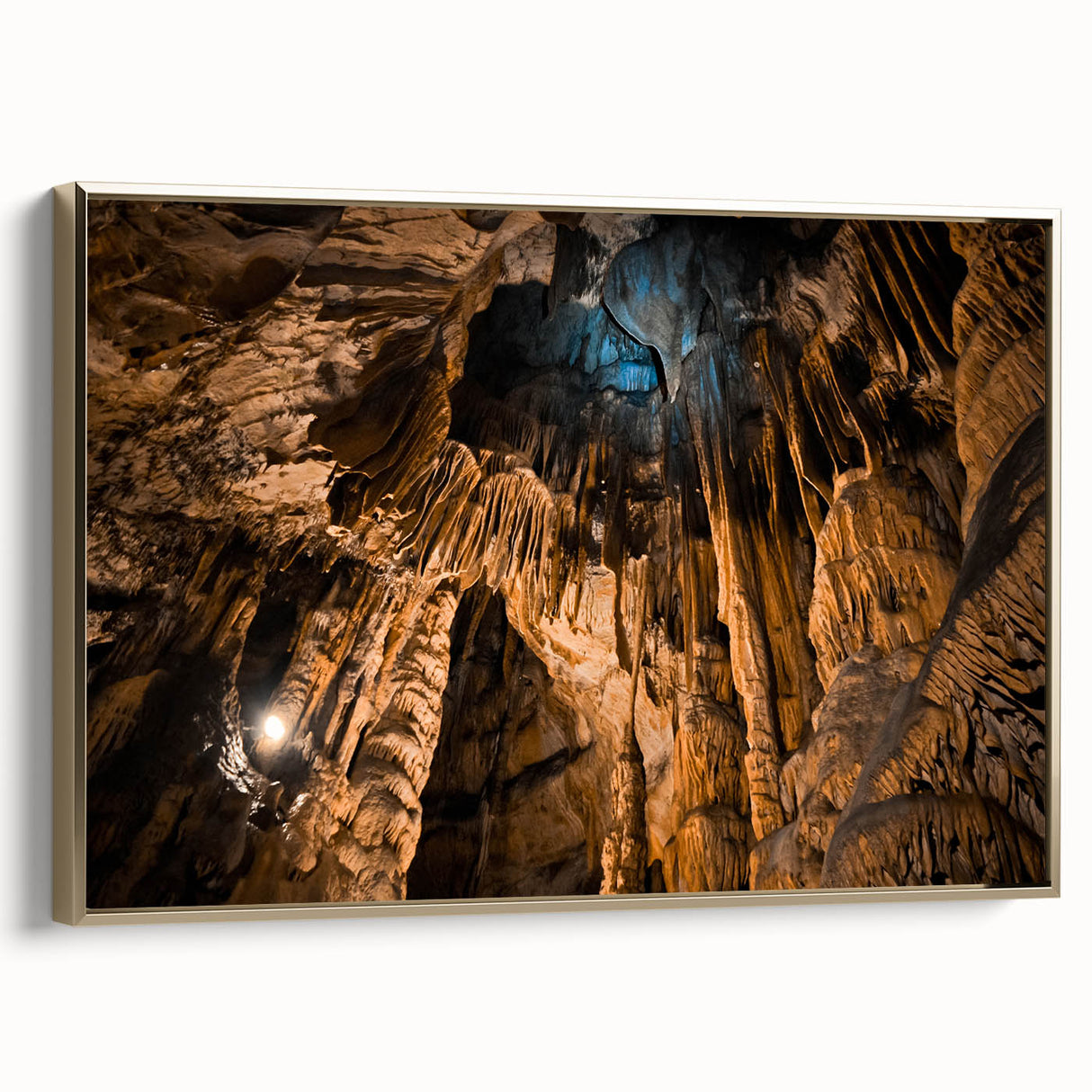 Framed canvas featuring a vintage-style landscape painting of a European scenery in muted gold and black tones.