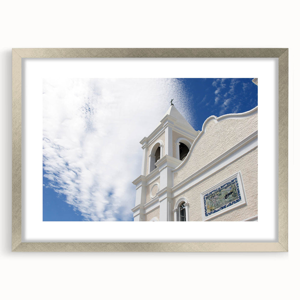 Textured art print of Cabo San Lucas scenery in muted earth tones, framed with a silver mat, suitable for bedroom decor.