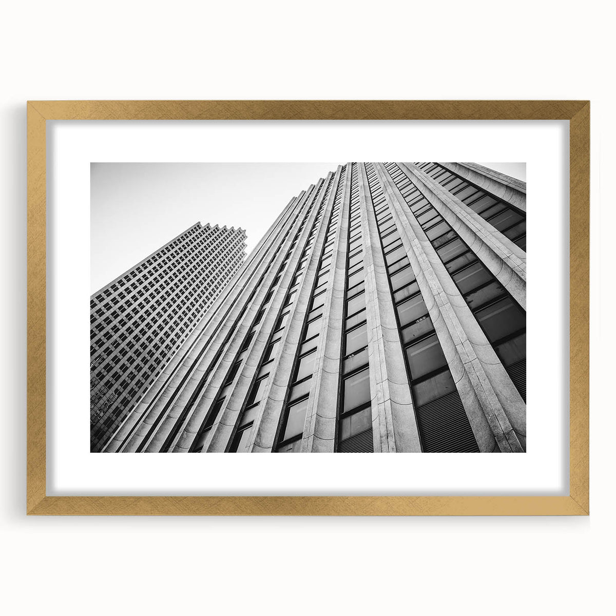 Extra large abstract art print of Houston skyline, gold-framed with textured details, in muted earth tones.