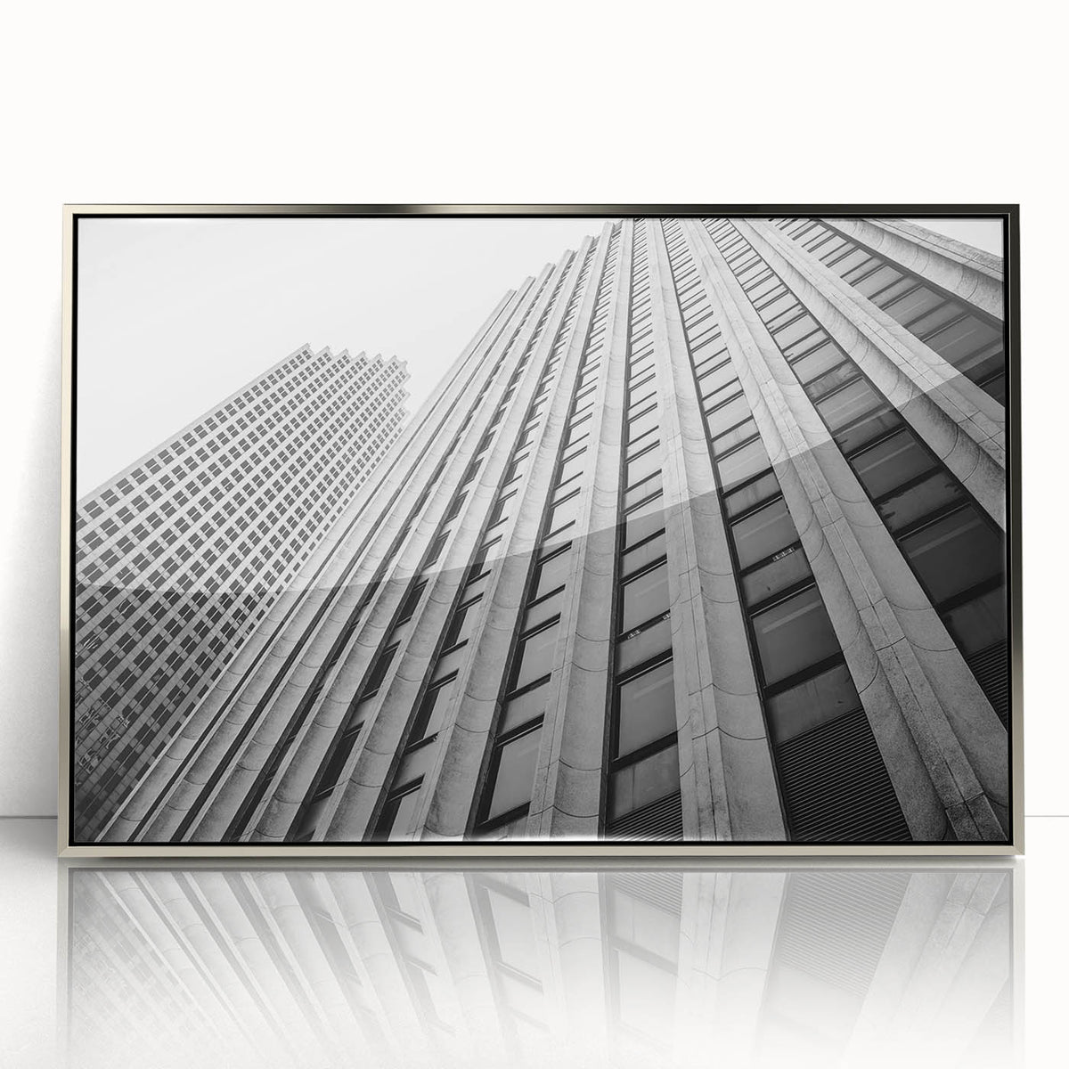 Mid-century modernist art featuring Houston skyline in muted gray and blue tones on a silver-framed acrylic print.