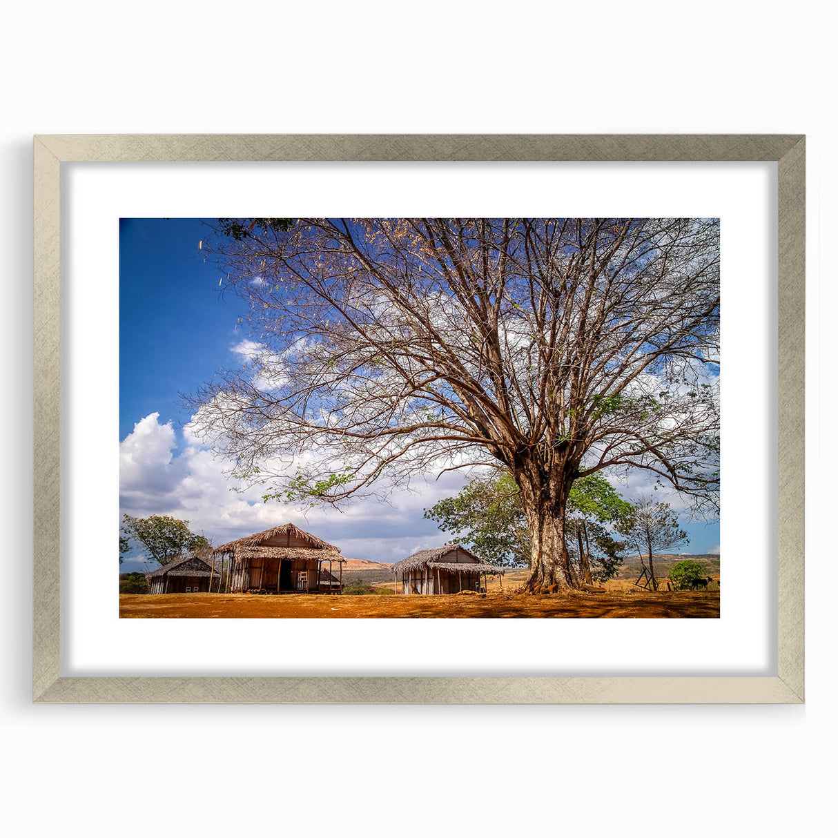 Abstract art print of a Madagascar scenery in muted earth tones, framed in silver, ideal for dining room decor.