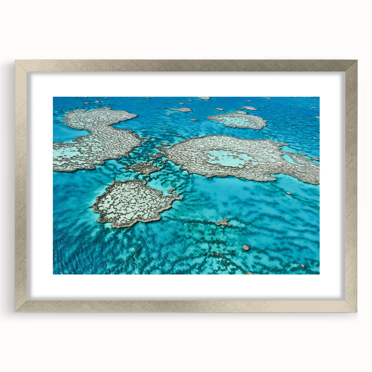 Abstract art print of the Great Barrier Reef in blue and green tones on a framed canvas, ideal for dining room decor.