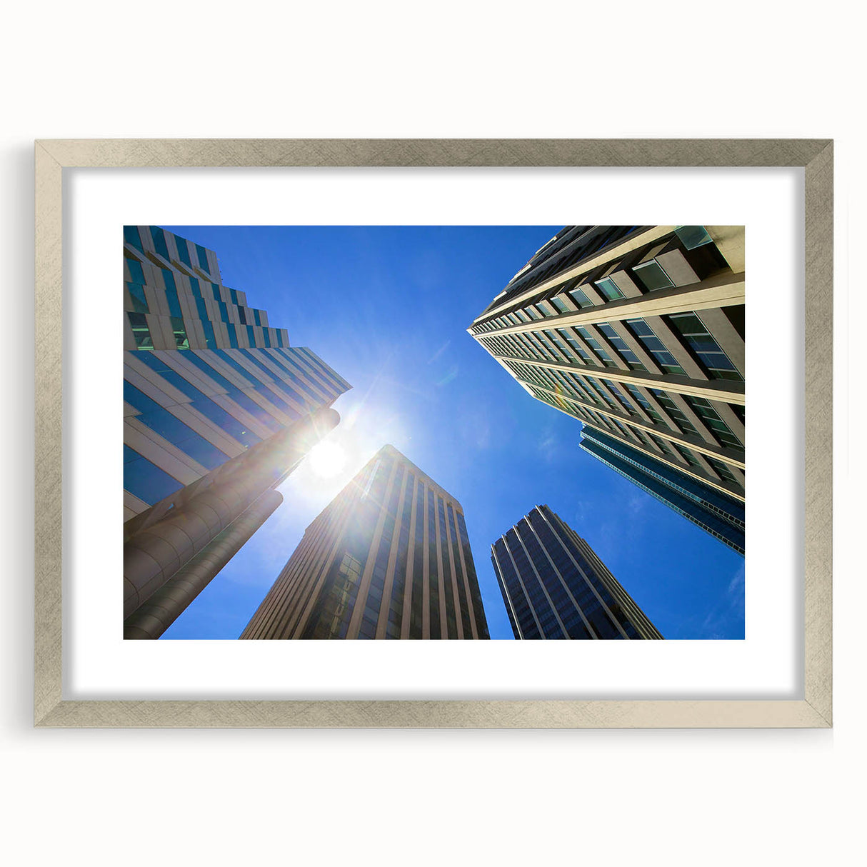 Abstract art print of Perth skyline in muted blue and gray, framed in silver, ideal for dining room decor.