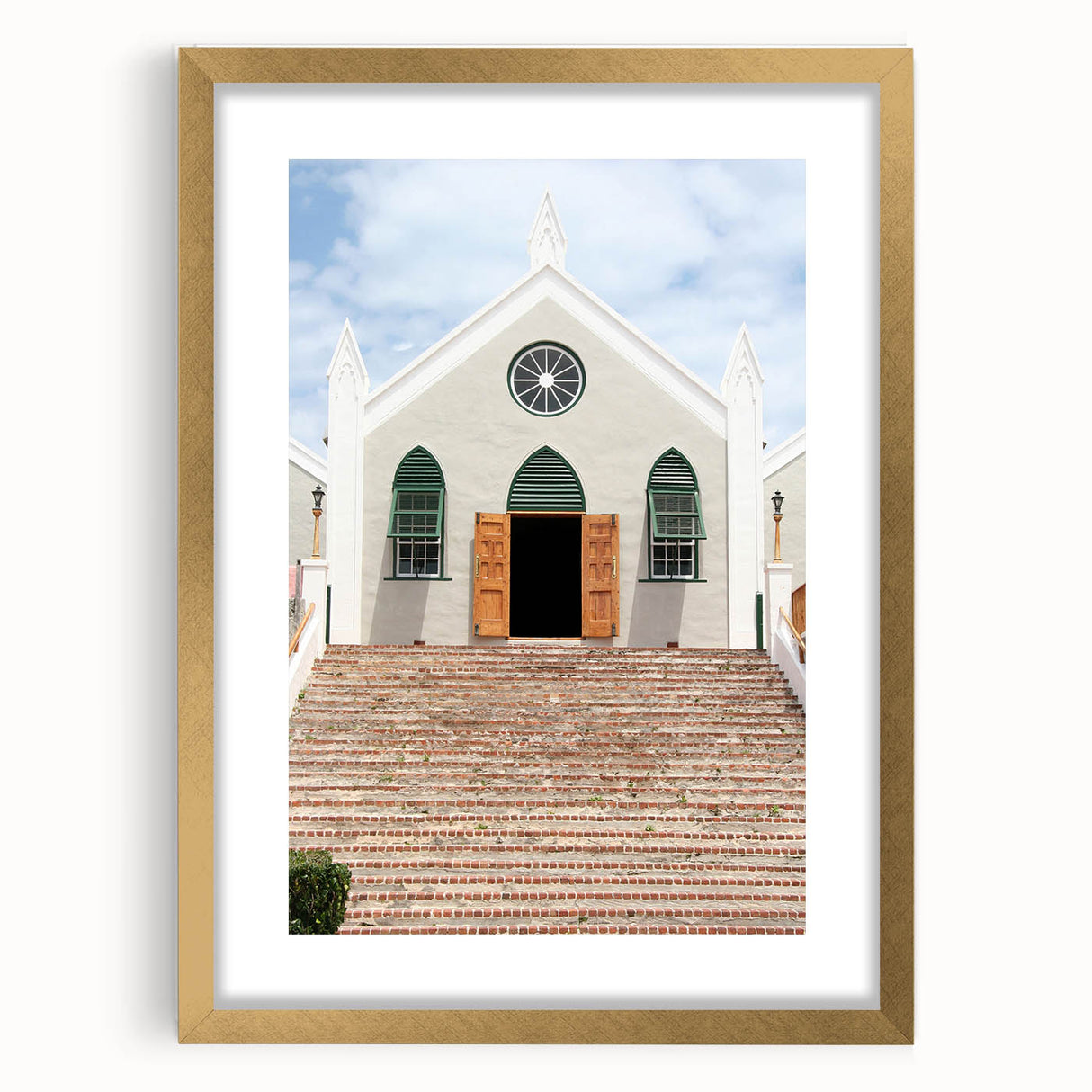 Abstract art print of Caribbean scenery in muted blue and green tones, framed in gold.