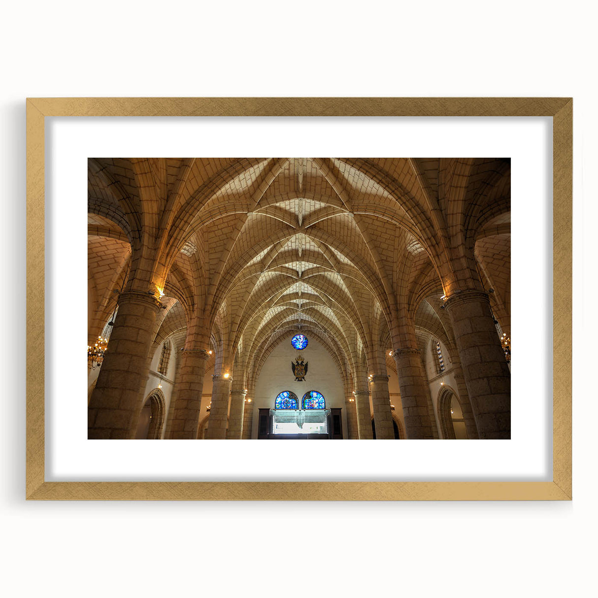 Abstract art print depicting Caribbean scenery in muted blues and greens, framed in gold.