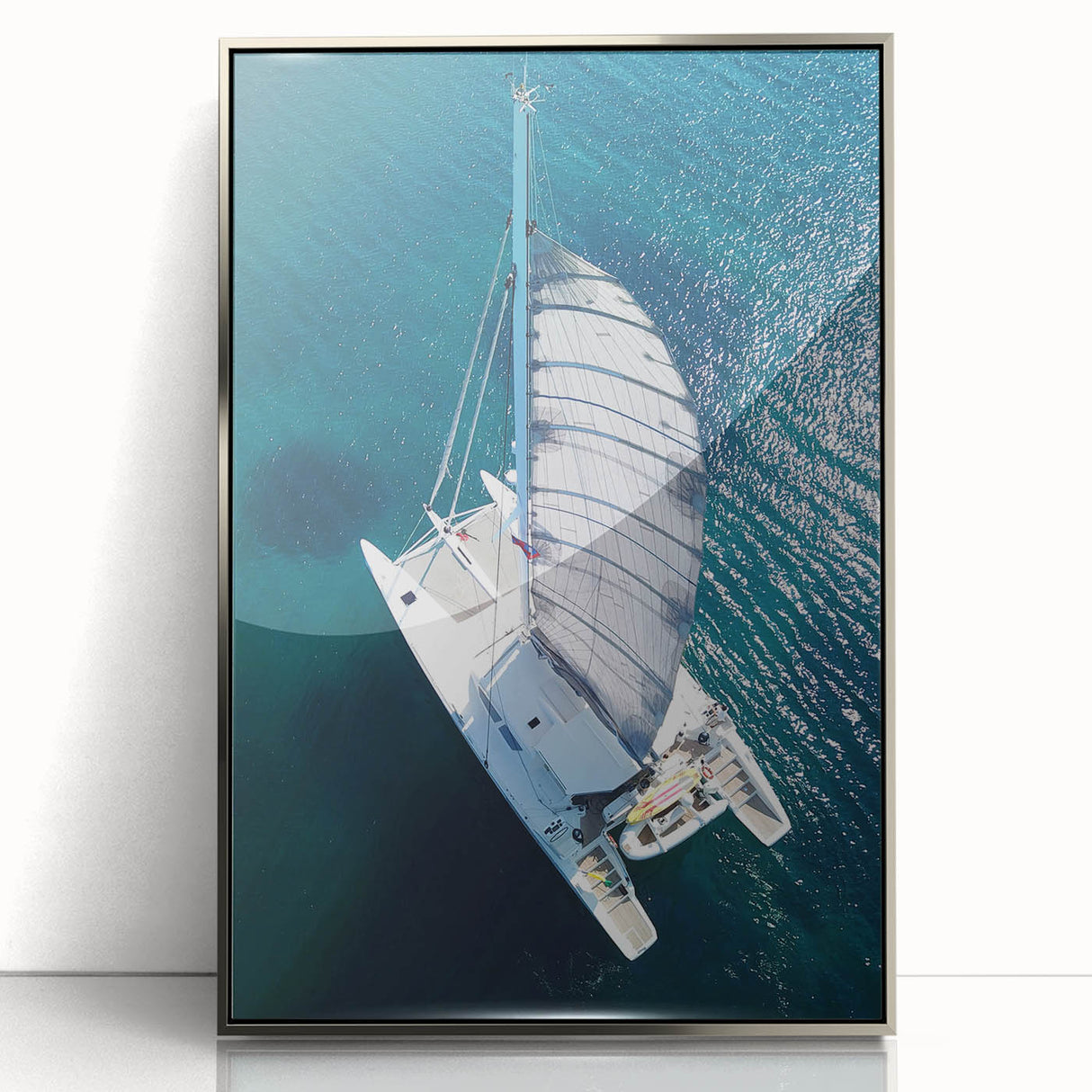 Art deco poster of a Caribbean scene in muted blue and green tones, framed in silver acrylic.