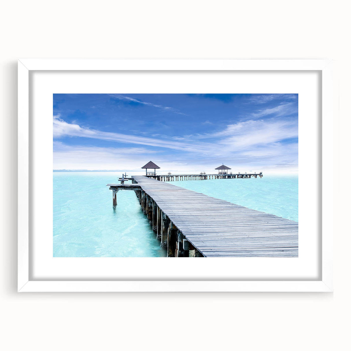 Abstract art print of Cancun scenery in muted blue and green tones, framed with a white mat.