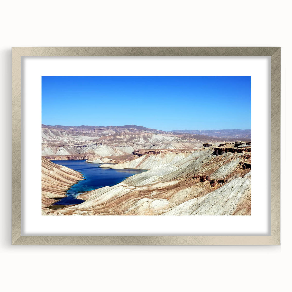 Textured abstract art print depicting a Middle Eastern scenery in muted earth tones, framed with a silver mat.