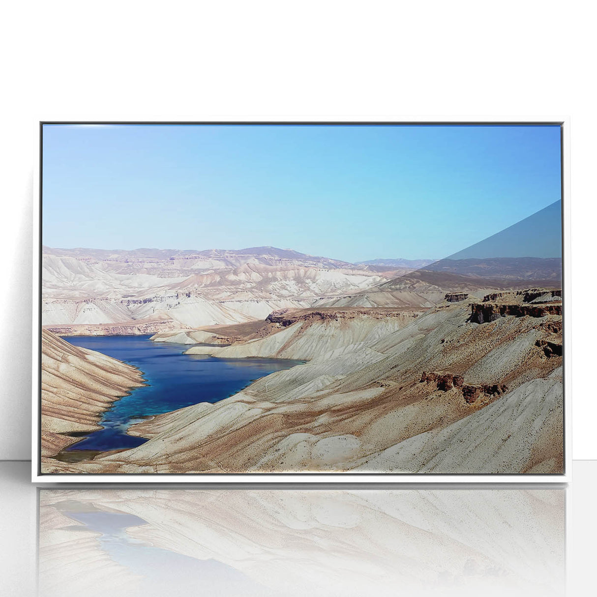 Acrylic print of an Afghan landscape in muted earth tones, framed in white, suitable for modern art wall decor.