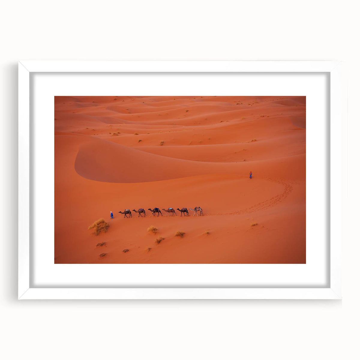Abstract art print depicting a Middle Eastern landscape in muted earth tones on a framed white canvas.