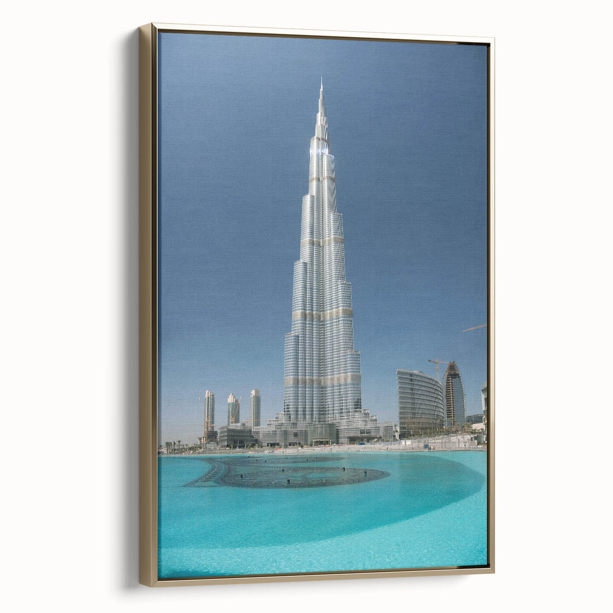 Framed canvas wall art featuring a side view of Burj Khalifa set against a golden skyline, ideal for bedroom decor.