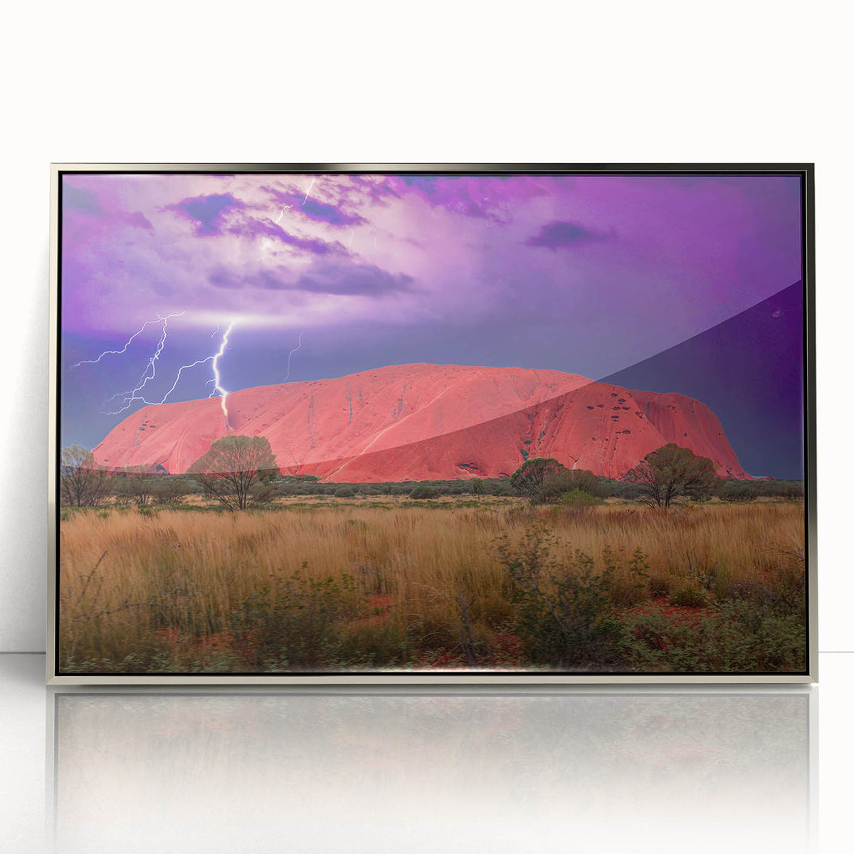Acrylic print of Ayers Rock in muted earth tones, framed in silver, suitable as modern art wall decor.