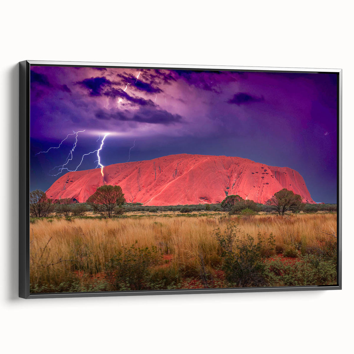 Framed canvas featuring a black and white landscape of Ayers Rock, ideal for bedroom wall art.