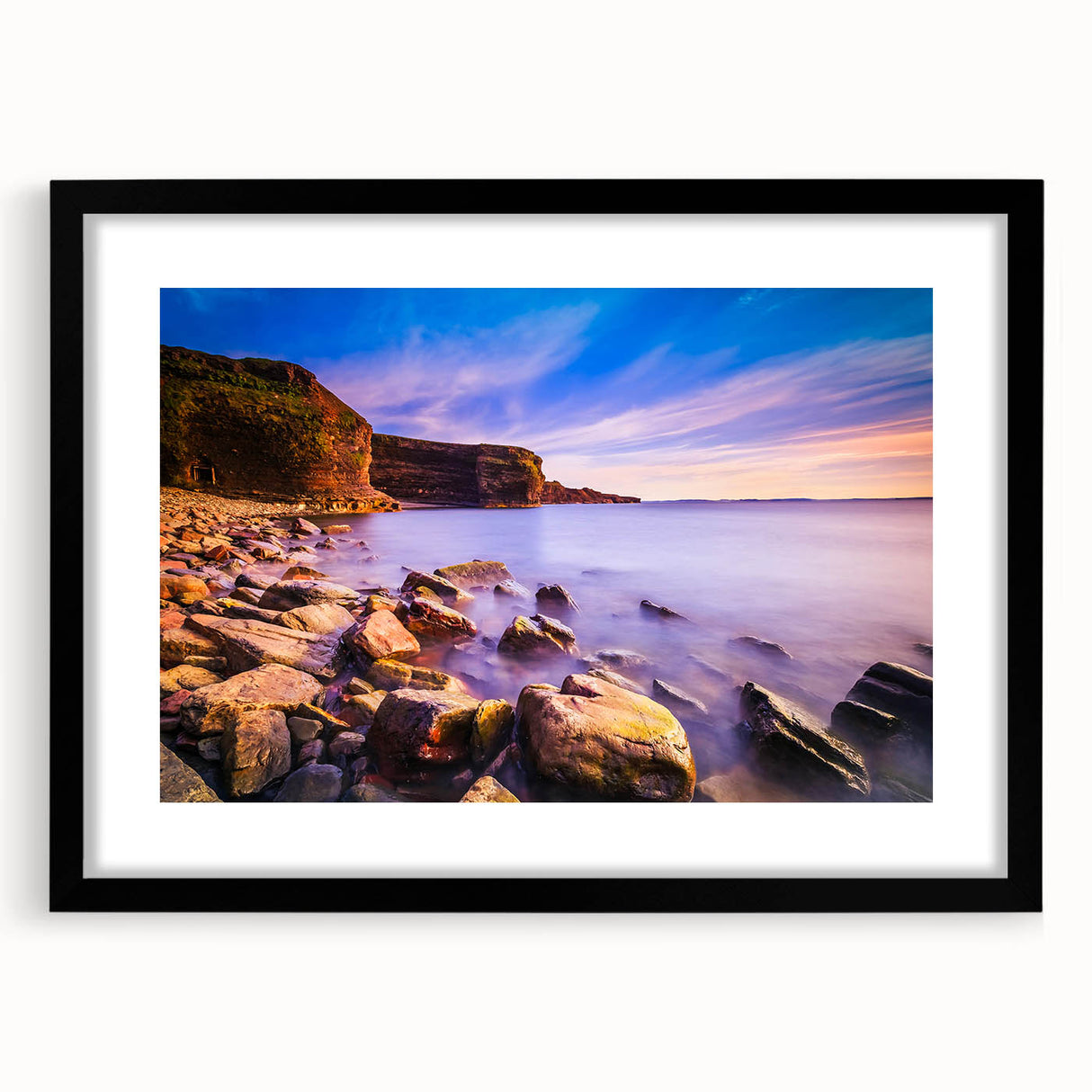 Extra large, textured abstract art print of vibrant, colorful scenery, framed in black, ideal for living room decor.