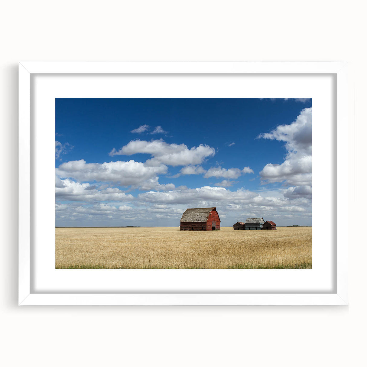 Abstract art print of Saskatchewan scenery in muted green and blue tones, framed with a white mat.