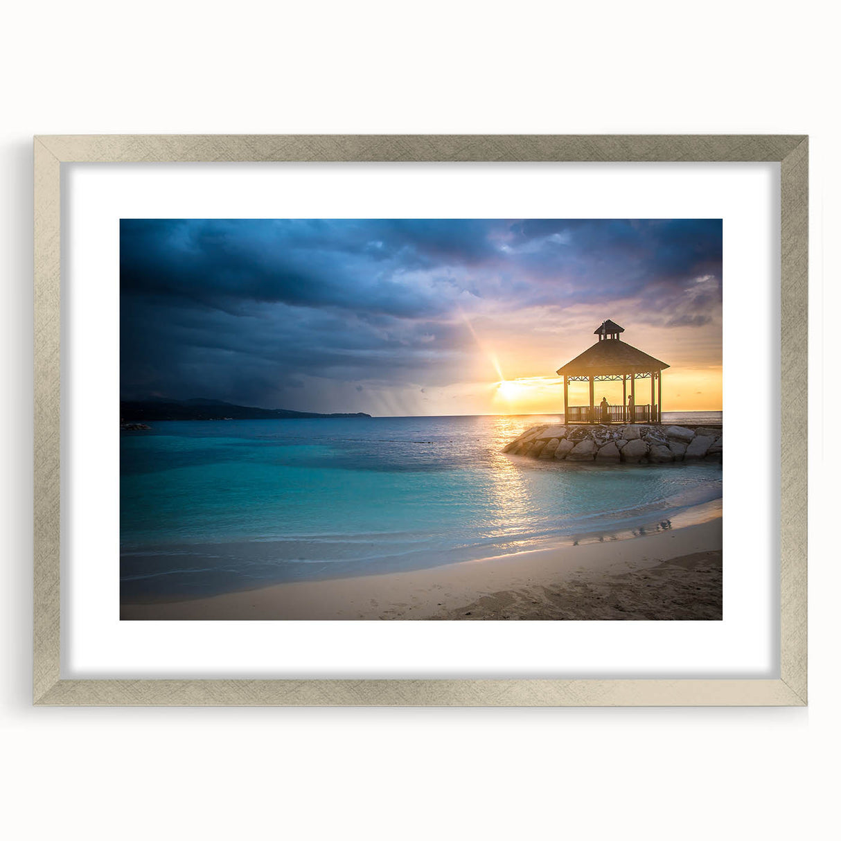 Abstract art print of Caribbean scenery in muted blue and green tones, framed in silver, suitable for dining room decor.