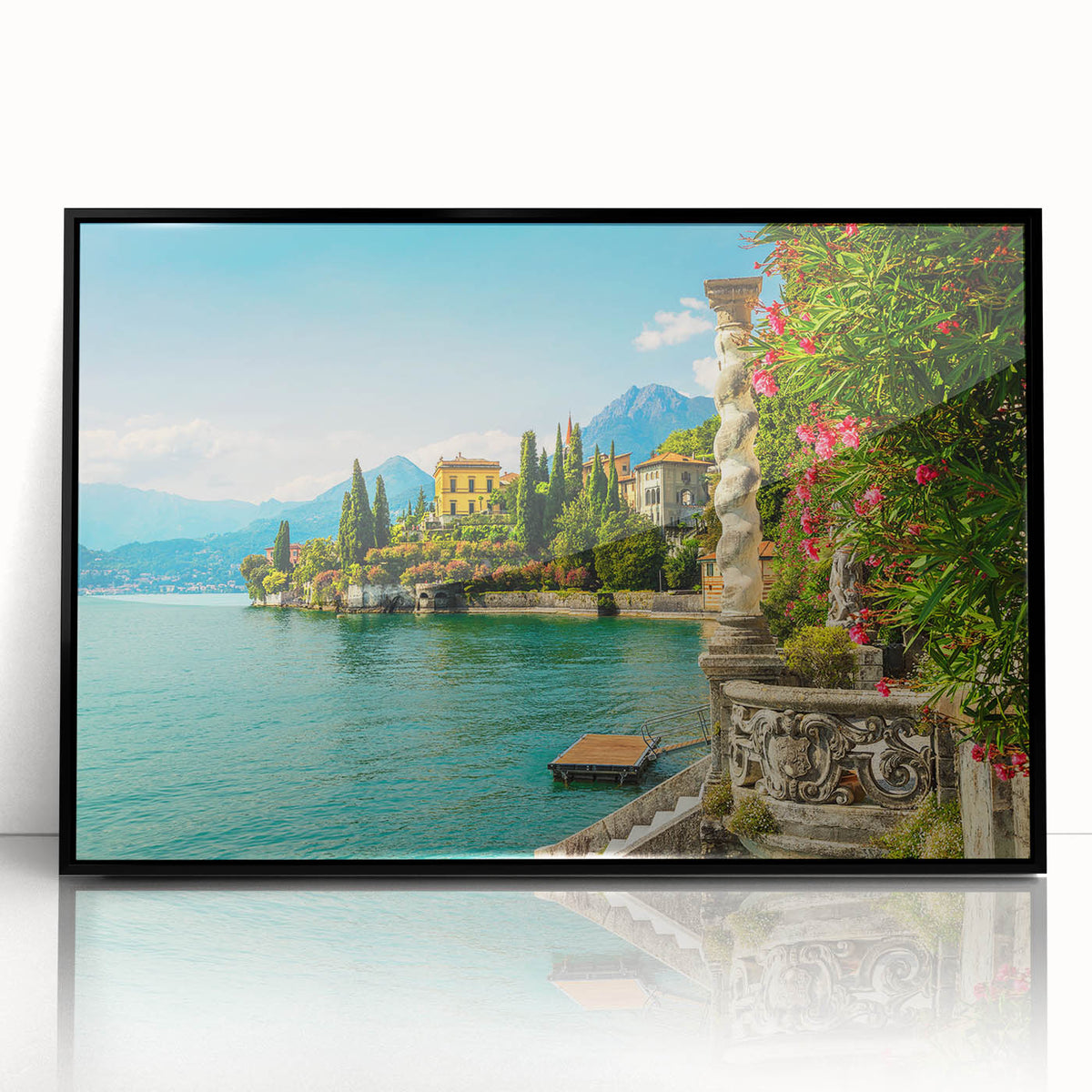 Large abstract wall art of Lake Como in muted blue and green tones, framed in black acrylic.