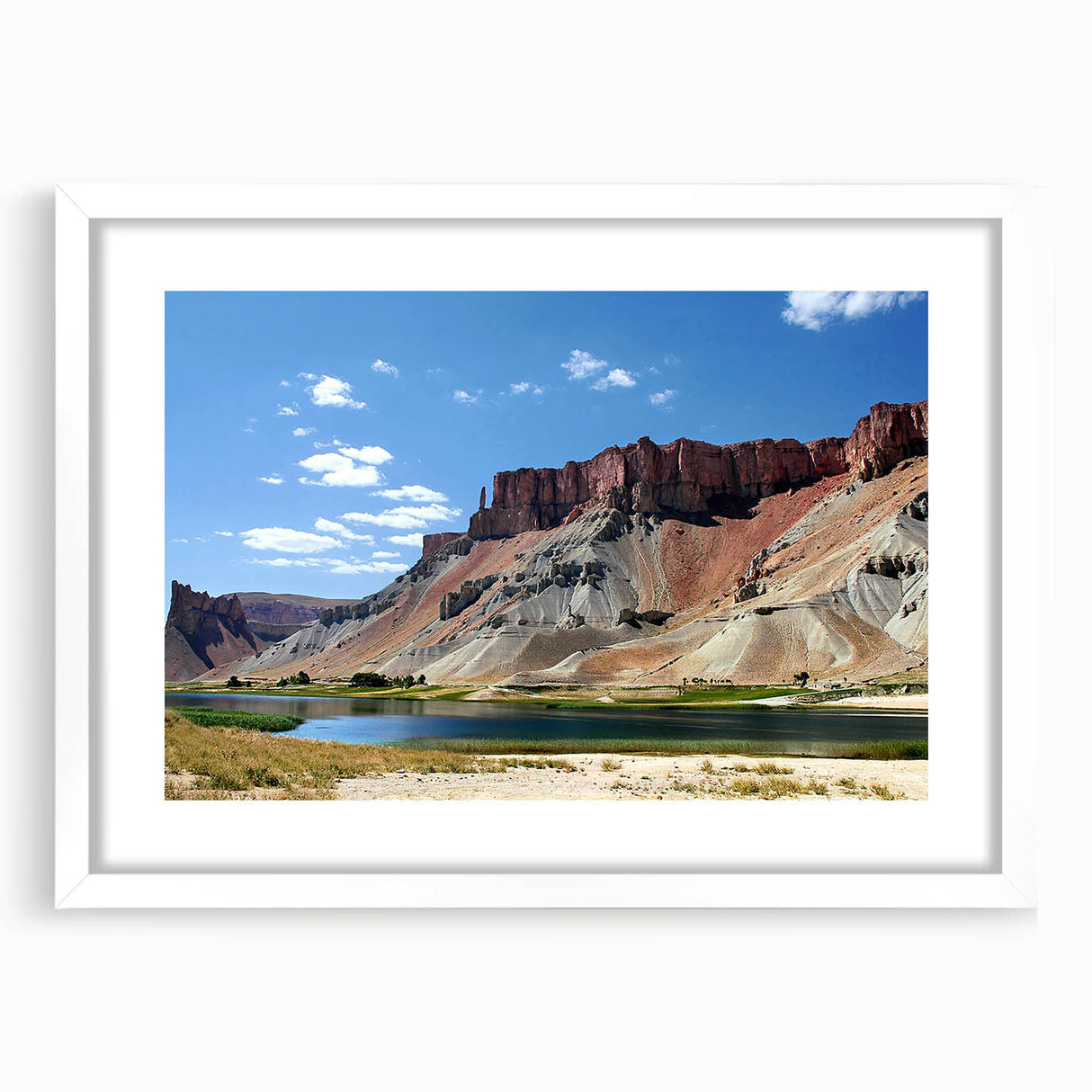 Abstract art print of a Middle Eastern landscape in muted earth tones on a white-framed canvas.
