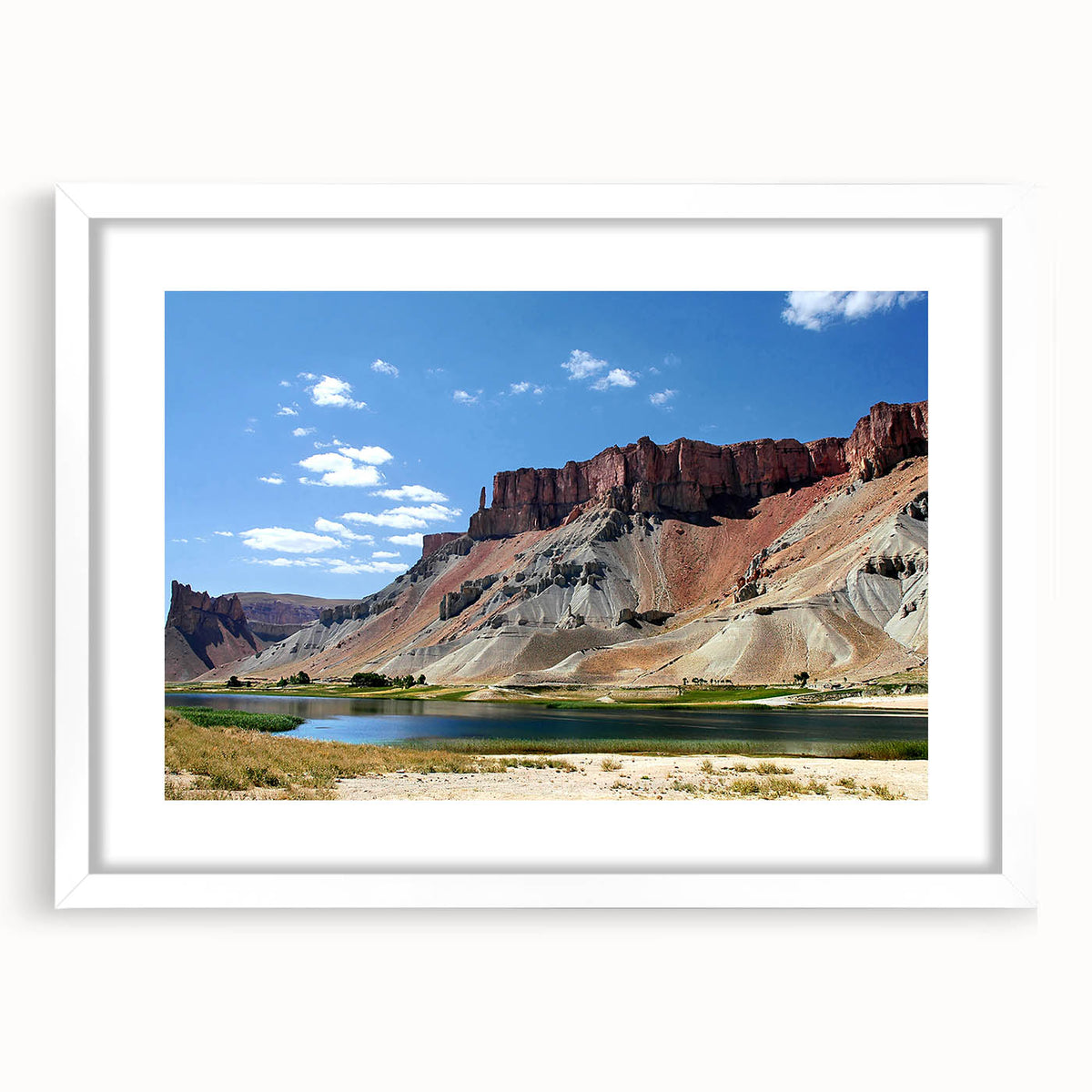 Abstract art print of a Middle Eastern landscape in muted earth tones on a white-framed canvas.