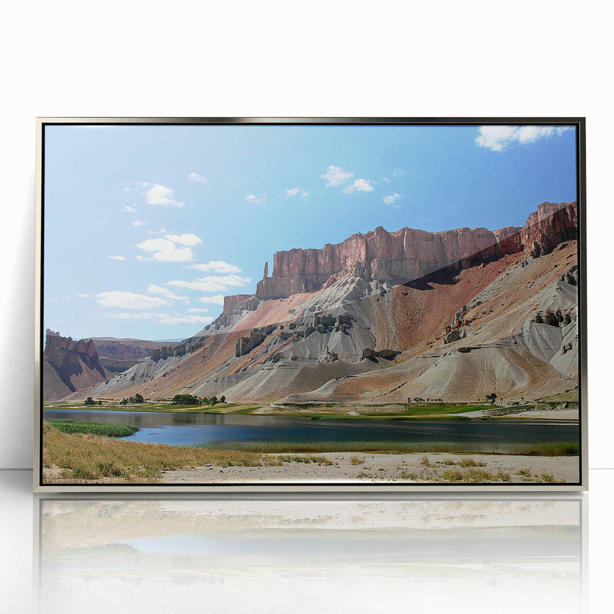 Mid-century modernist art depicting a serene Middle Eastern landscape in muted earth tones, framed in silver acrylic.