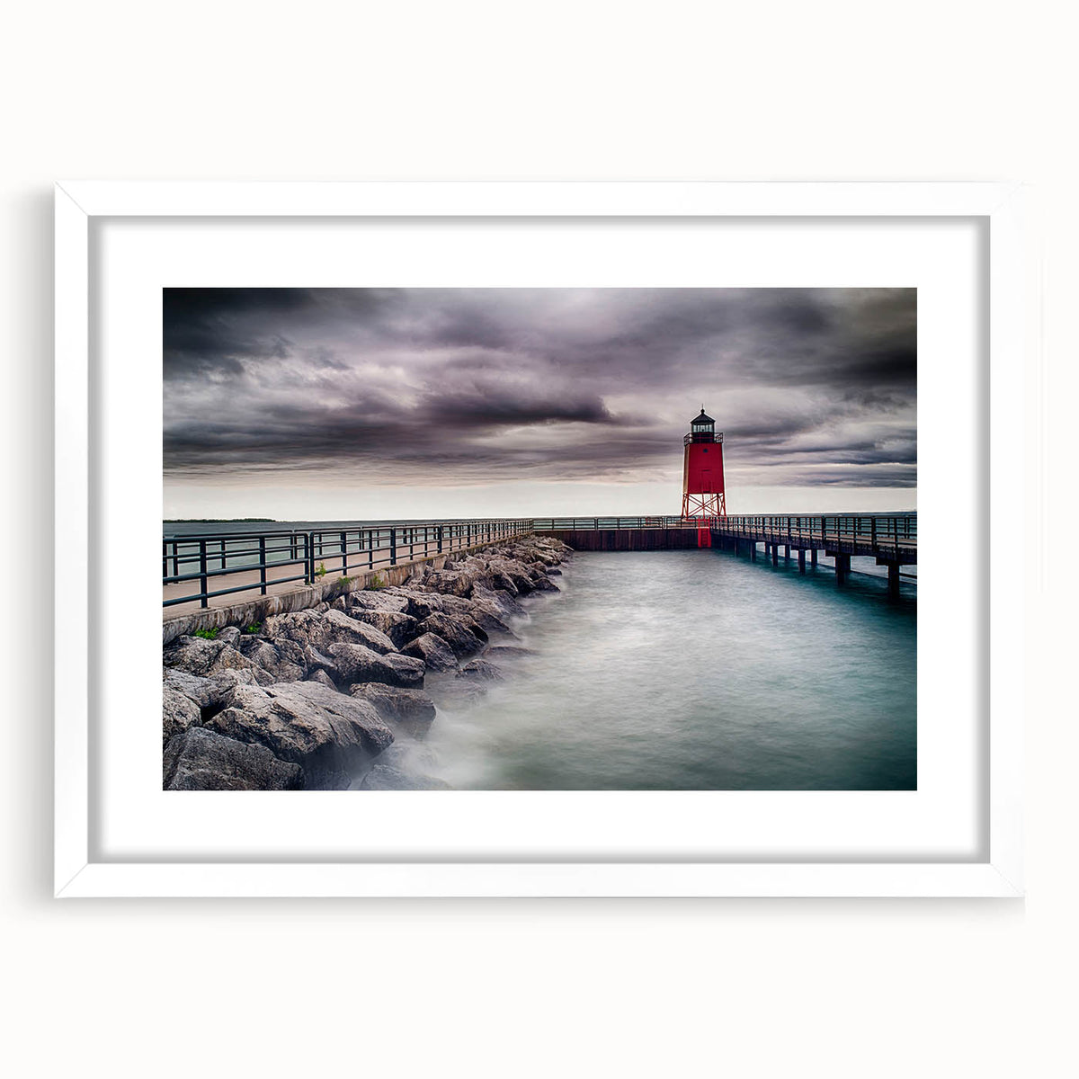 Abstract art print of Lake Michigan in muted blue and gray tones on a framed white mat, ideal for dining room decor.