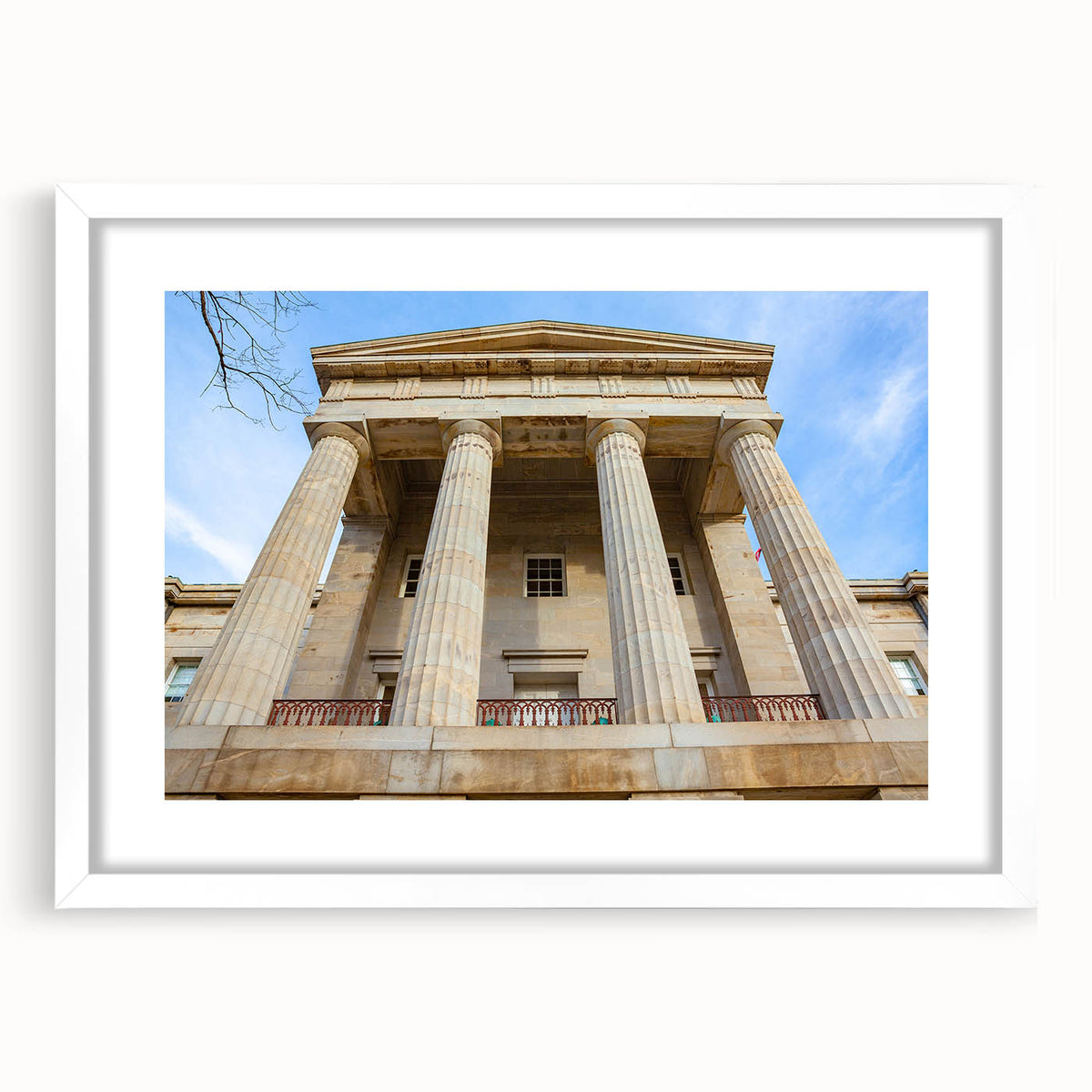 Abstract art print of Raleigh skyline in muted gray and blue tones on a framed white matte canvas.