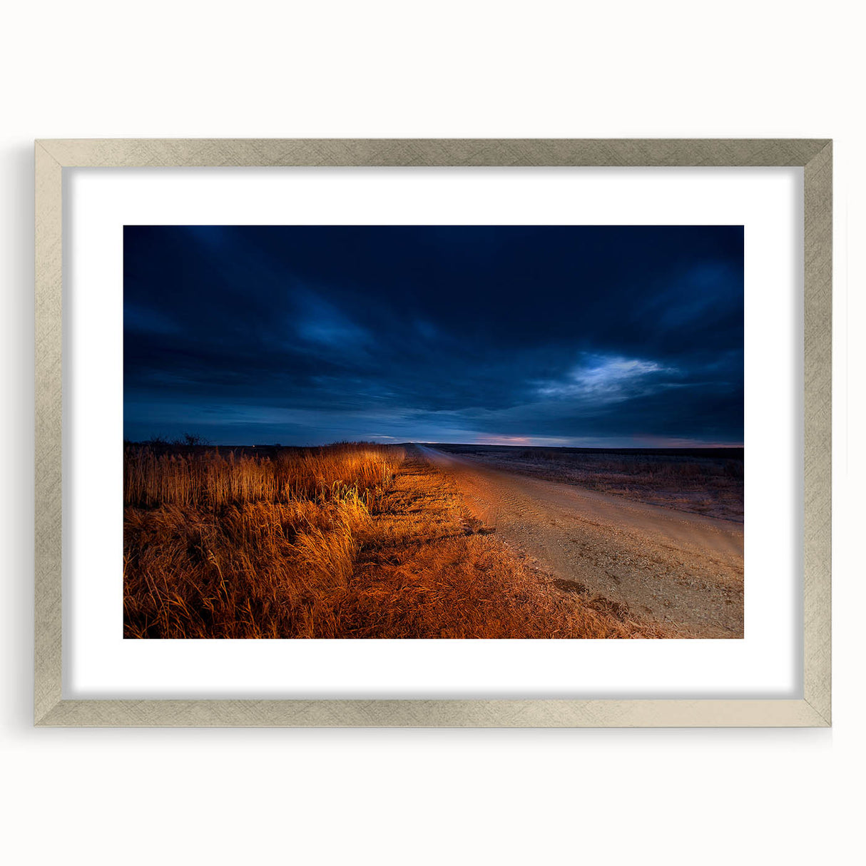 Textured art print of abstract North Dakota scenery in muted earth tones, framed in silver, ideal for bedroom decor.